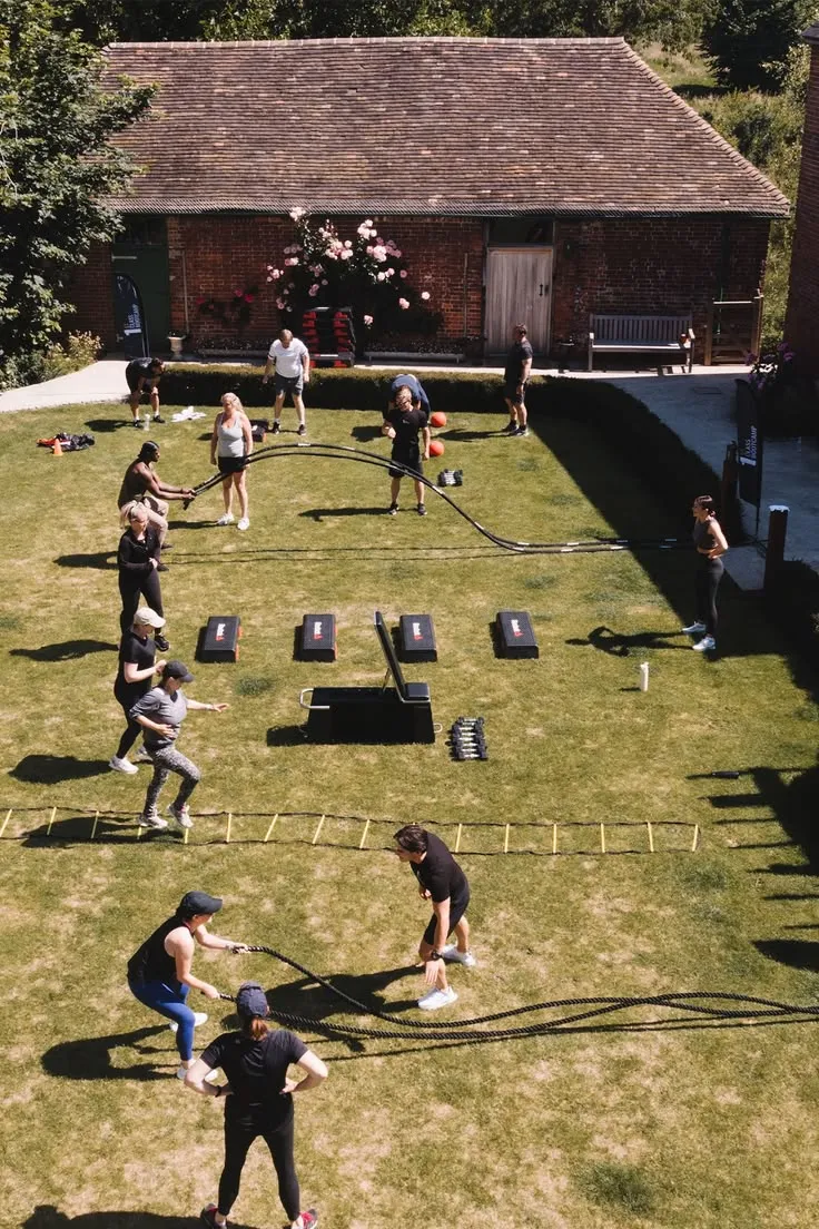 Group calisthenics session on outdoor terrain
